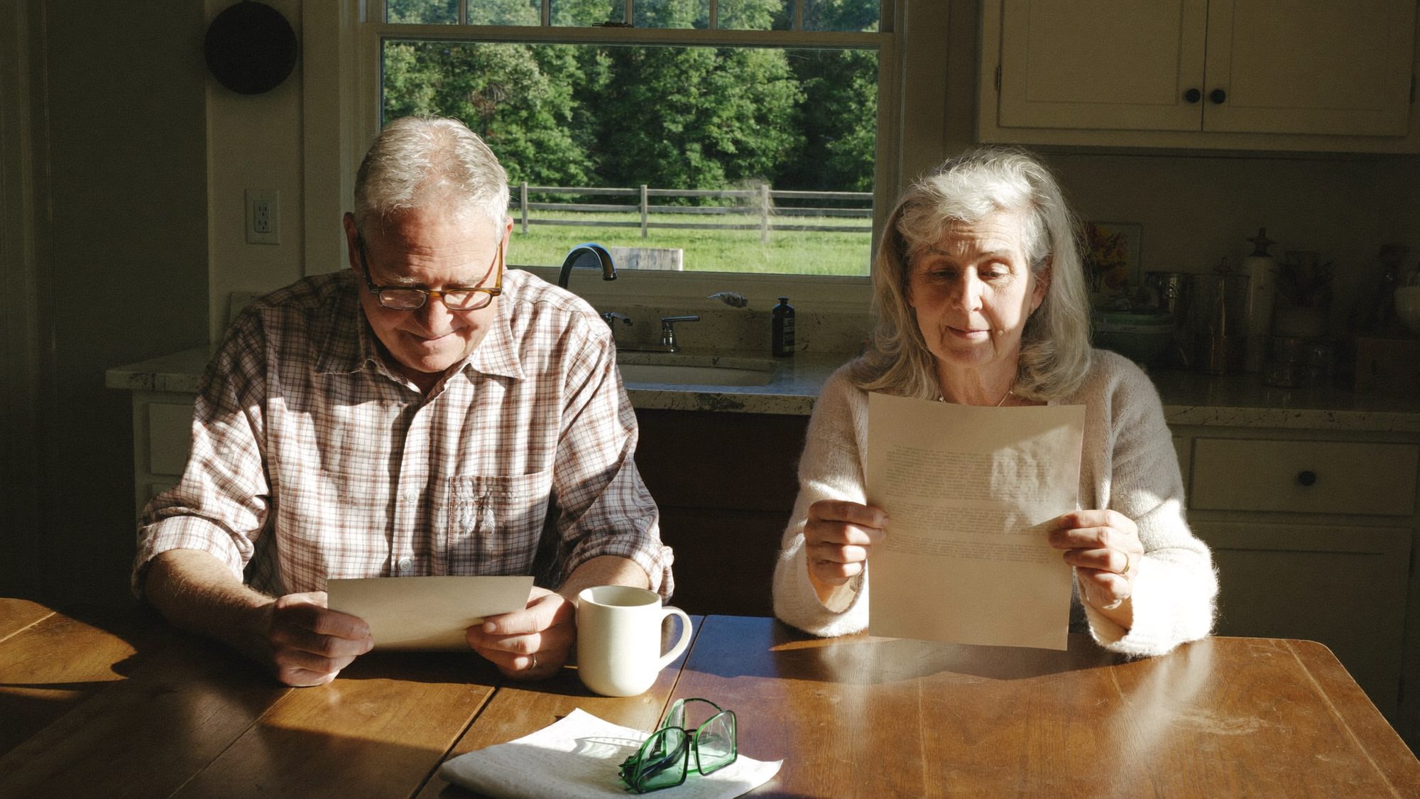 Older Georgia couple reviewing a long-term care insurance rate increase letter together at their kitchen table