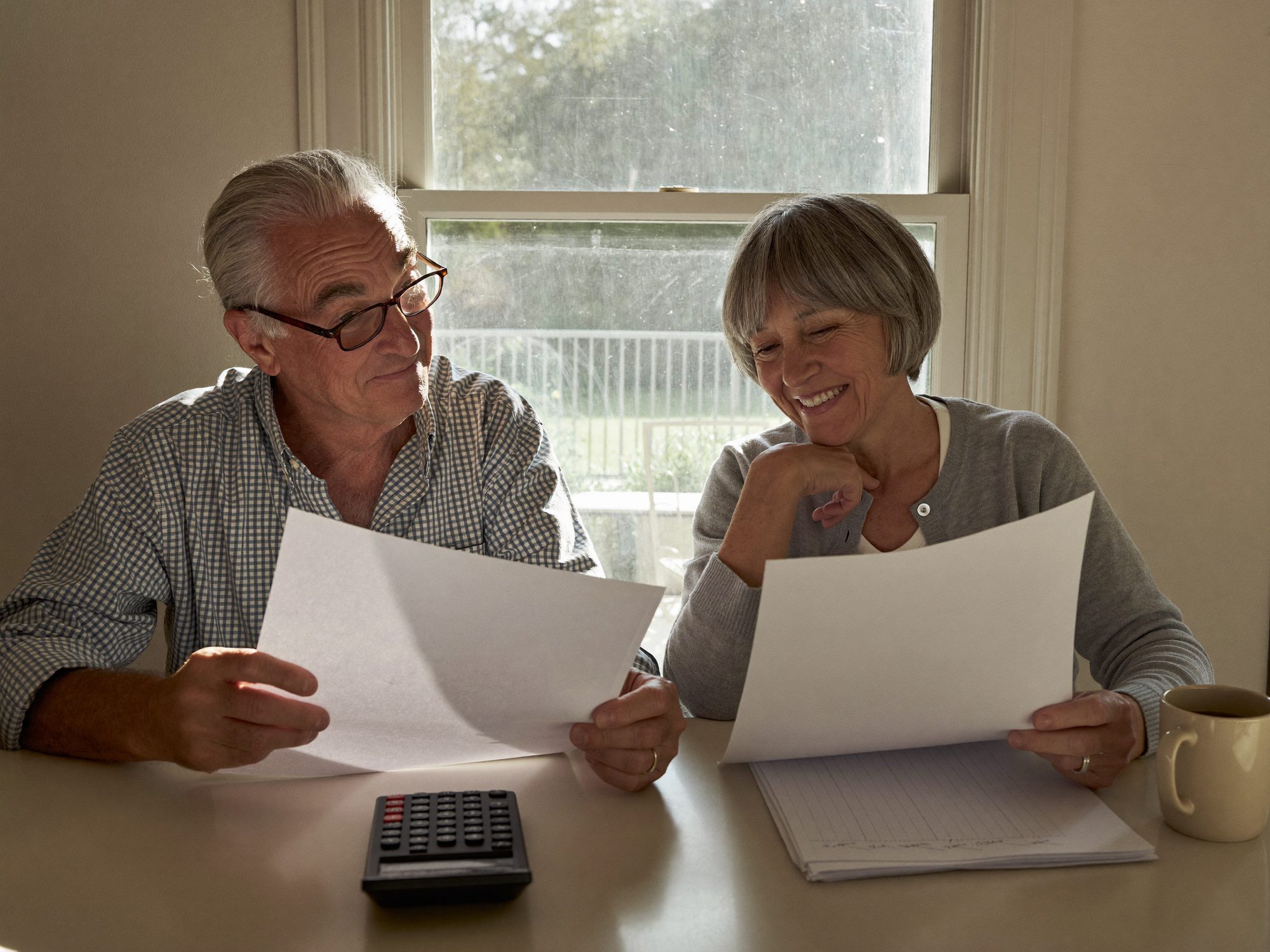 Older couple reviewing Social Security claiming options at their kitchen table in rural Georgia
